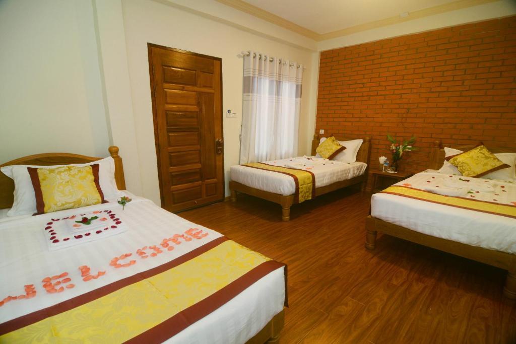 Triple room with three single beds at A Little Bit of Bagan Hotel